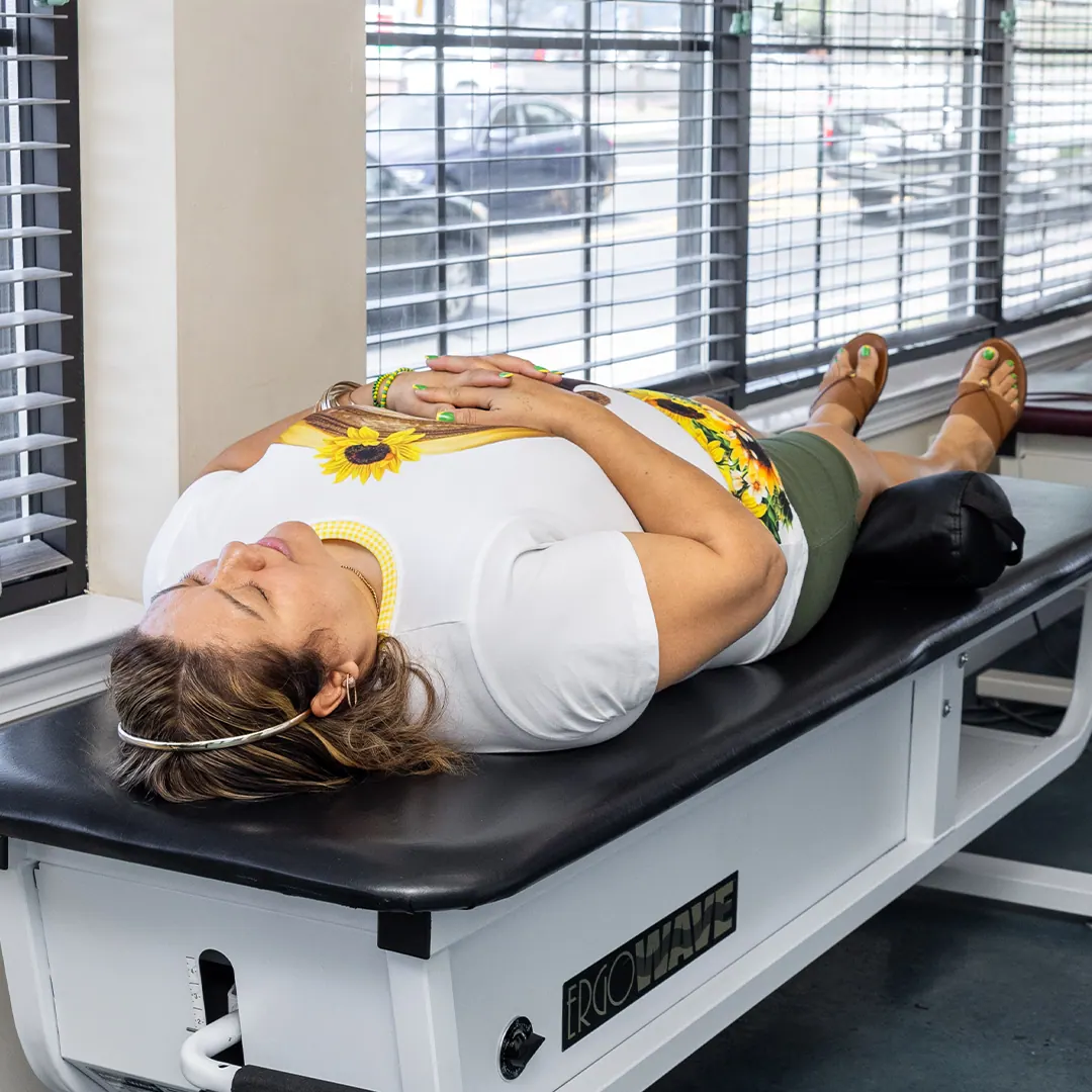 Woman lying in spinal decompression table