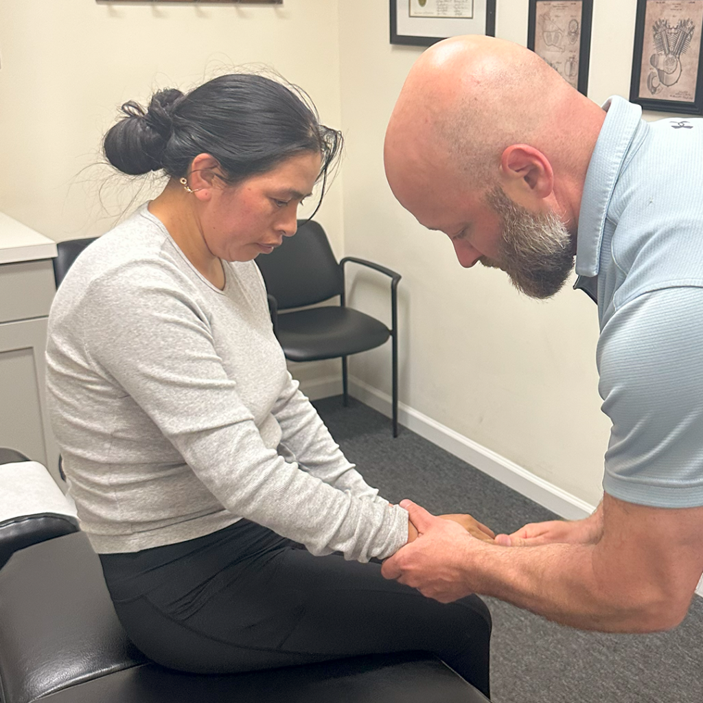 Dr. Eric Chludzinski treating carpal tunnel pain on patient