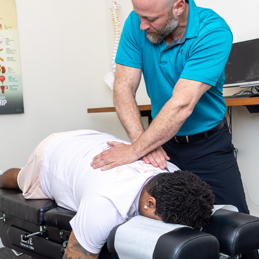 Dr. Eric Chludzinski back pain adjustment on patient