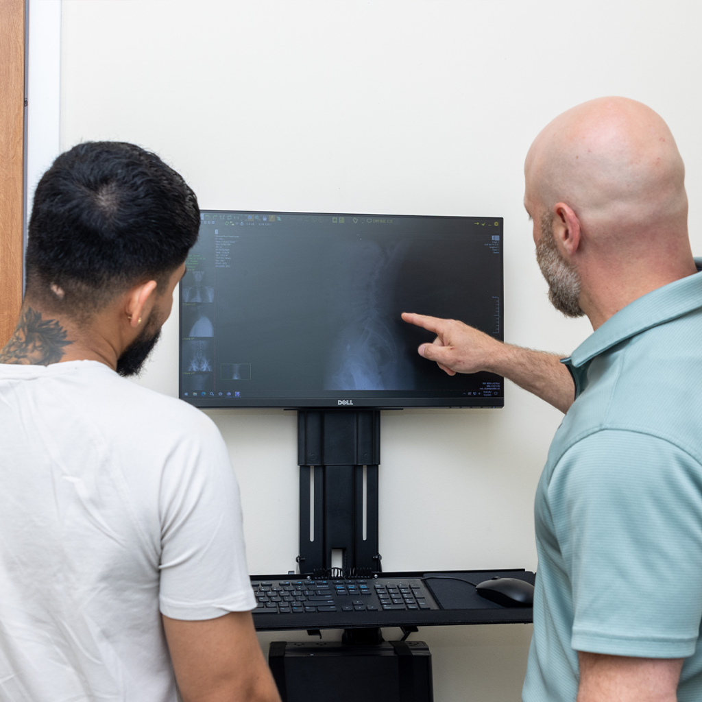 Dr. Eric Chludzinski showing patients xray